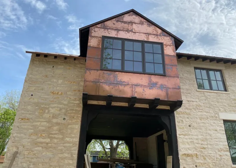 Copper metal panel facade on a stone building for Roof Repair in Ormond-by-the-Sea