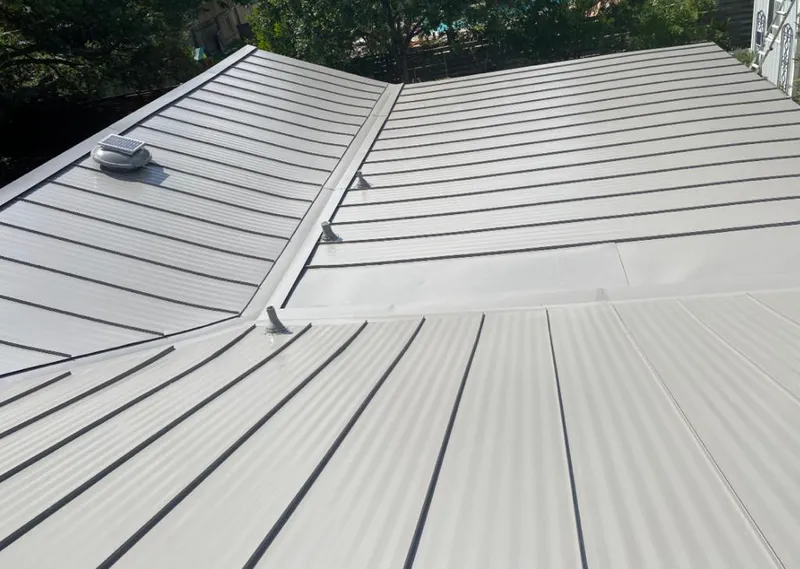 Solar attic fan installed on a metal roof for Roof Ventilation in Ormond-by-the-Sea