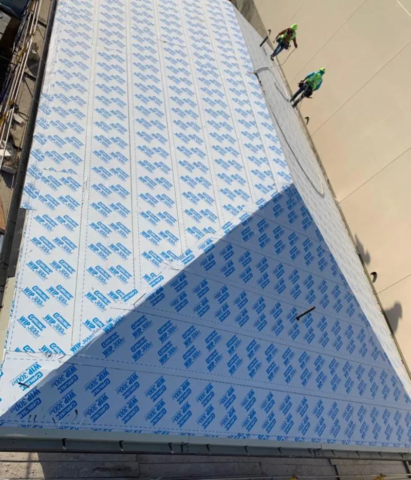 Professional roofers installing underlayment on a metal roof in Ormond-by-the-Sea